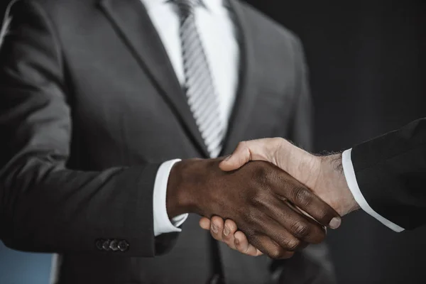 Multicultural businessmen handshake — Stock Photo