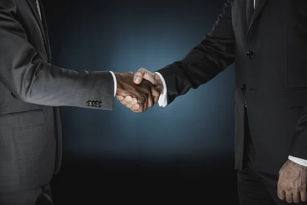 Multicultural businessmen handshake — Stock Photo