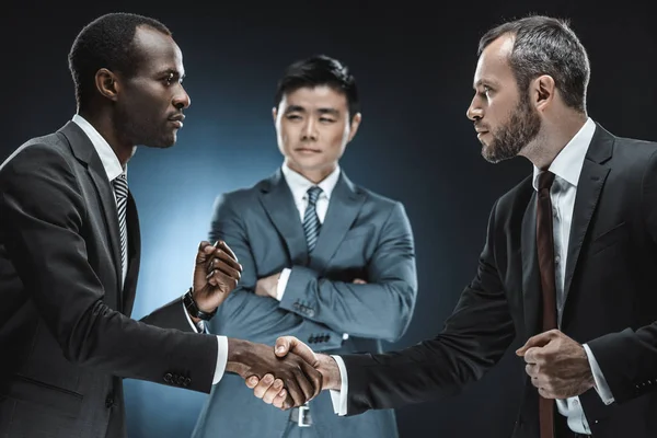 Multiethnic business partners shaking hands — Stock Photo