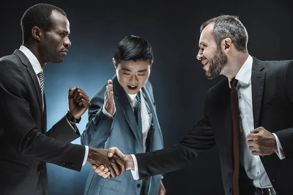 Multiethnic business partners shaking hands — Stock Photo