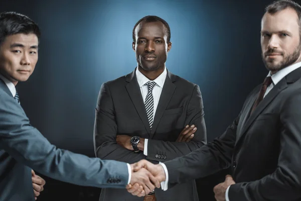 Multiethnic business partners shaking hands — Stock Photo