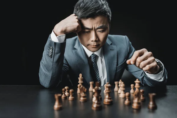 Asiatique homme d'affaires et pièces d'échecs — Photo de stock