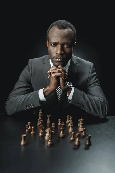 African american businessman and chess figures — Stock Photo