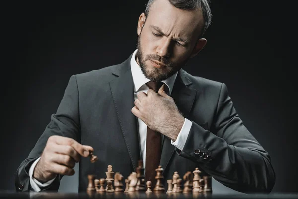 Businessman playing chess — Stock Photo