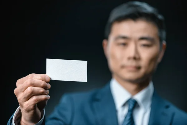 Asian businessman with business card — Stock Photo