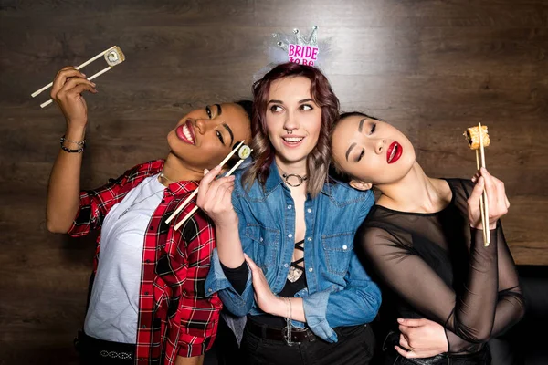 Multicultural women with sushi at hen party — Stock Photo