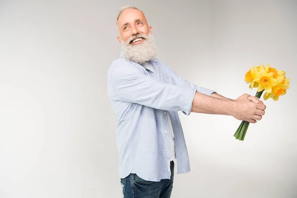 Cheerful senior man with bouquet — Stock Photo