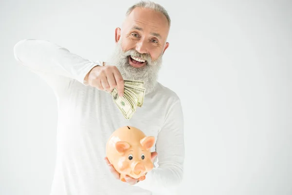 Man with dollars and piggy bank — Stock Photo