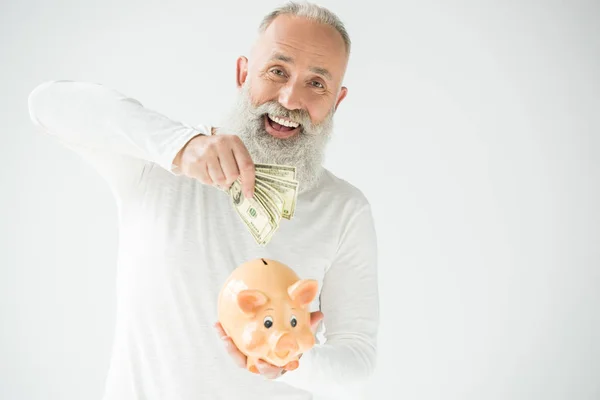 Mann mit Dollars und Sparschwein — Stockfoto