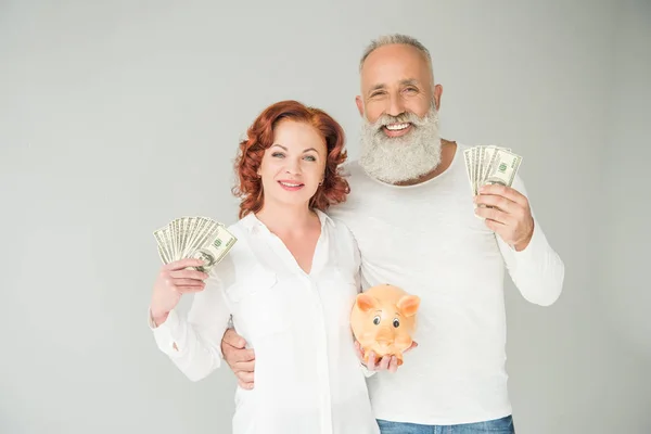 Couple with dollars and piggy bank — Stock Photo