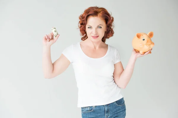 Woman with dollars and piggy bank — Stock Photo