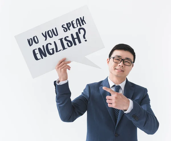 Asian businessman with card with question — Stock Photo