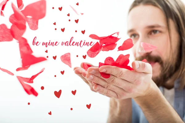 Man blowing paper hearts — Stock Photo