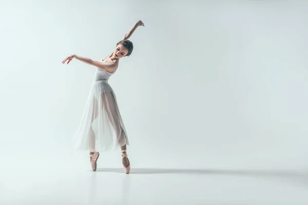 Elegant ballerina dancing in studio, isolated on white — Stock Photo