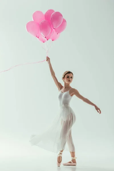 Elegant ballerina with pink balloons, isolated on white — Stock Photo