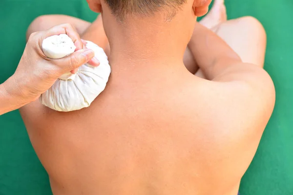 Back neck massage. Massage therapist massaging back neck of a ma