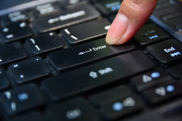 Finger pushing enter button on keyboard. Finger pressing — Stock Photo, Image