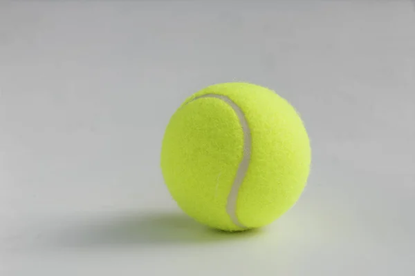 Single yellow tennis ball on the background close up — Stock Photo, Image