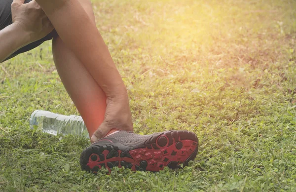 The guy clings to a bad leg. The pain in his leg after exercise. The pain is highlighted in red.