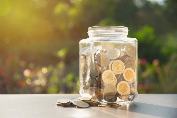 Coins in jar with money stack, Concept finance, accounting, business and saving investment. — Stock Photo, Image
