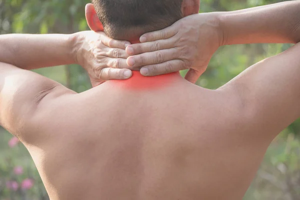 Man suffering from neck pain. Acute pain in a man muscle concept with red spot.