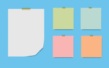 Boş kare not defteri sayfaları ve teyp. Not kağıdı bej yapışkan bant ile sıkışmış.