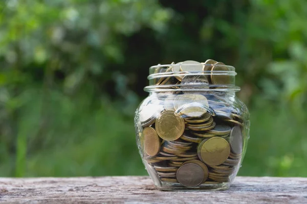 Saving money concept with money coin in glass jar for financial and accounting. financial and accounting concept. — Stock Photo, Image