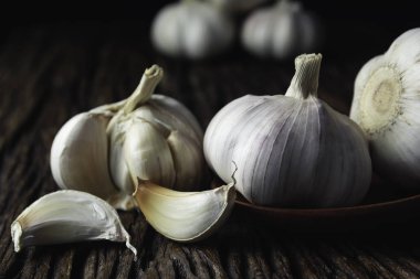 Fresh white garlic on wooden table with black background. Food a