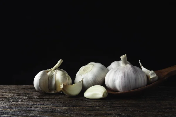 Fresh white garlic on wooden table with black background. Food a