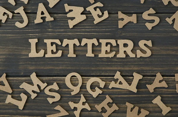 Word letters op een houten achtergrond — Stockfoto