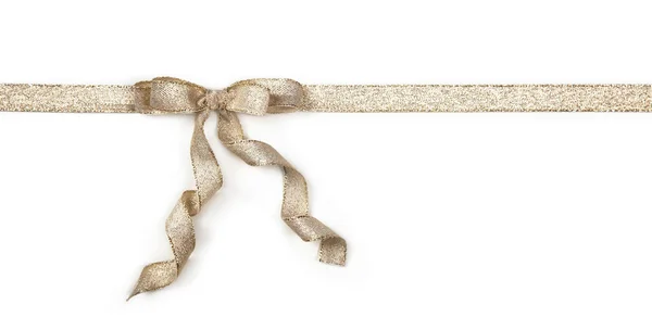 Golden ribbon with a bow — Stock Photo, Image