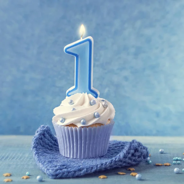 Cupcake with a blue candle — Stock Photo, Image