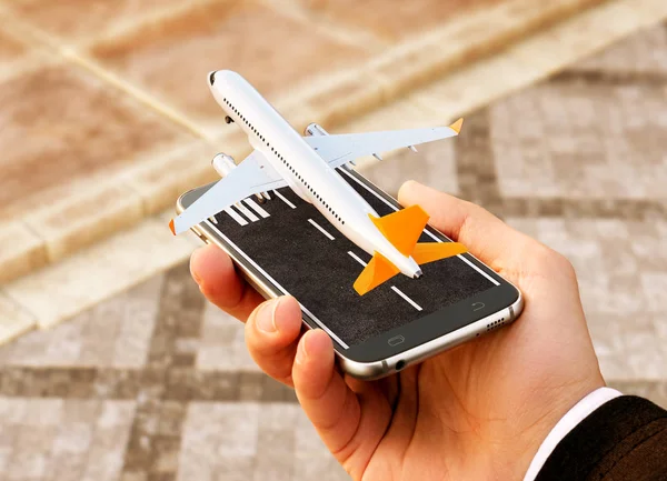 Smartphone application for online searching, buying and booking flights on the internet. Online check-in. Unusual 3D illustration of commercial airplane taking off on smart phone in hand — Stock Photo, Image