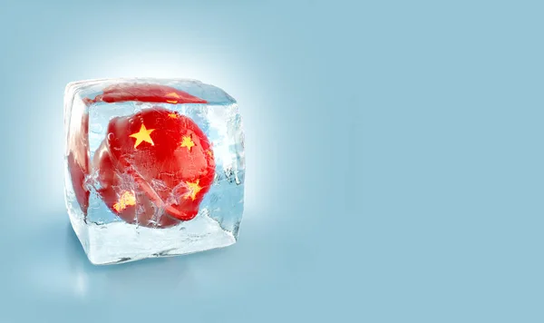 Beautiful red Christmas ball inside ice cube. — Stock Photo, Image