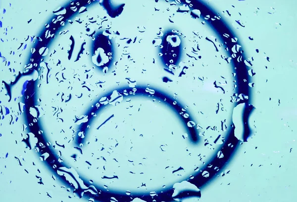 Sad blue smiley and water drops.