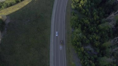 Genel kullanım için asfalt yol boyunca kova sürüşlü traktör