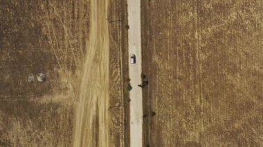 Aerial top down view car on the dirt dry road in tropical area