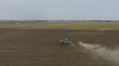 Aerial view tractor plows the field in Crimea.