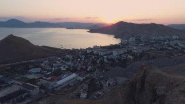 Dağın tepesindeki hava manzaralı kız telefonla fotoğraf çekiyor.