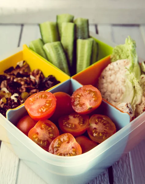 Fitness dinner with cucumbers, tomatosi, nuts and raisins, bread — Stock Photo, Image