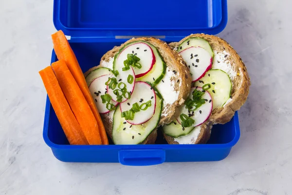 Sandwiches with cucumber and radishes, carrots lie in a snack co