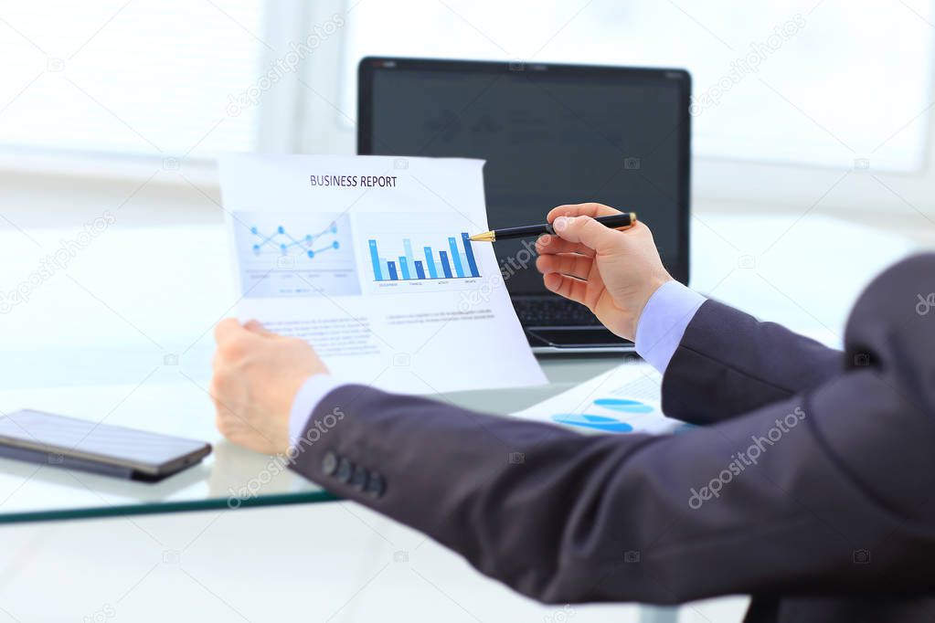 Businessman working with pen ,business documents on office table with smart phone and digital tablet and graph financial with social network diagram,laptop computer layer business information paper