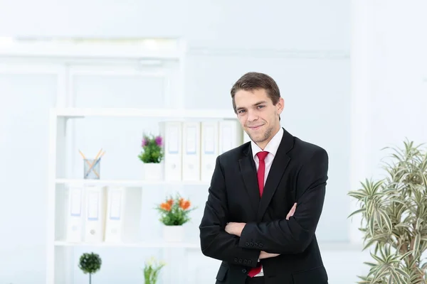 Portrait of happy businessman with arms crossed standing — Stock Photo, Image