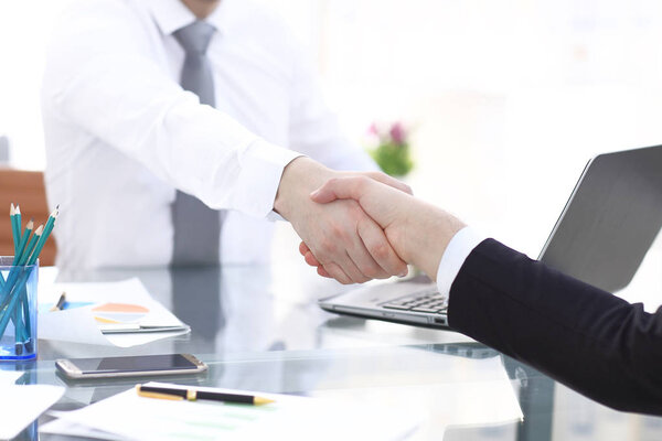 Close up view of business partnership handshake concept.Photo of two businessman handshaking process.Successful deal after great meeting.Horizontal,flare effect, blurred background
