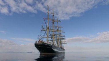 Aegean Sea - OCTOBER 2016. Russian Training Sailing Ship. Old Four-Masted Barque In The Calm Mirror-Smooth Sea On The Background Of The Mountain Coast.