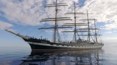 Aegean Sea - OCTOBER 2016. Russian Training Sailing Ship. Old Four-Masted Barque In The Calm Mirror-Smooth Sea On The Background Of The Mountain Coast.