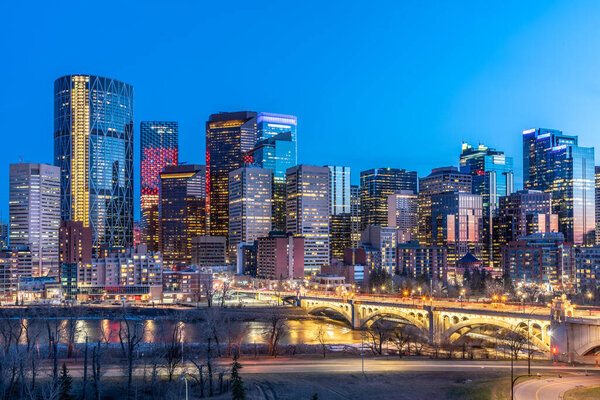 View of Calgary's beautiful skyline at night along the Bow River.