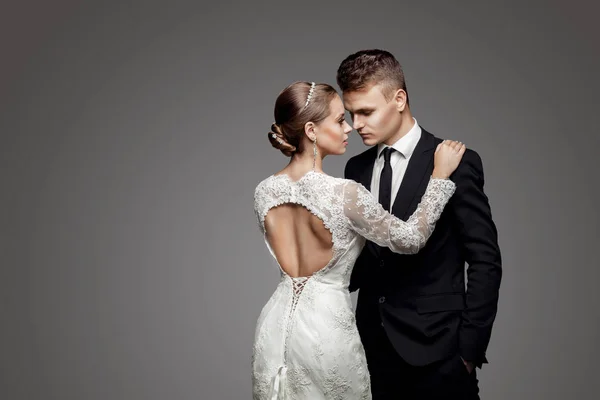 Groom in yellow bow-tie with bride, studio — Stock Photo, Image