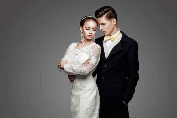 Groom in yellow bow-tie with bride, studio — Stock Photo, Image