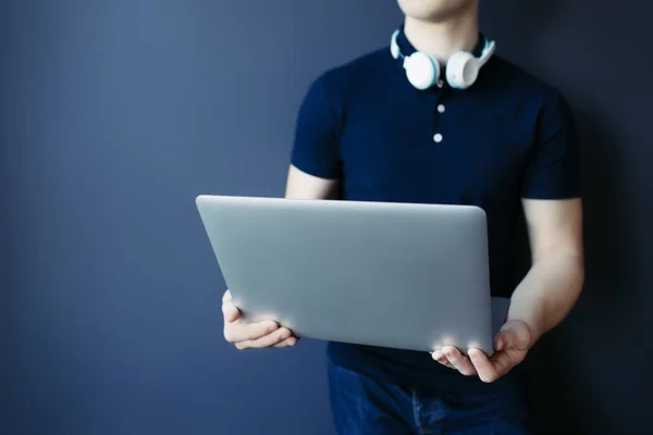 Laptop młody sportowiec mans ręce w t-shirt ze słuchawkami. — Zdjęcie stockowe